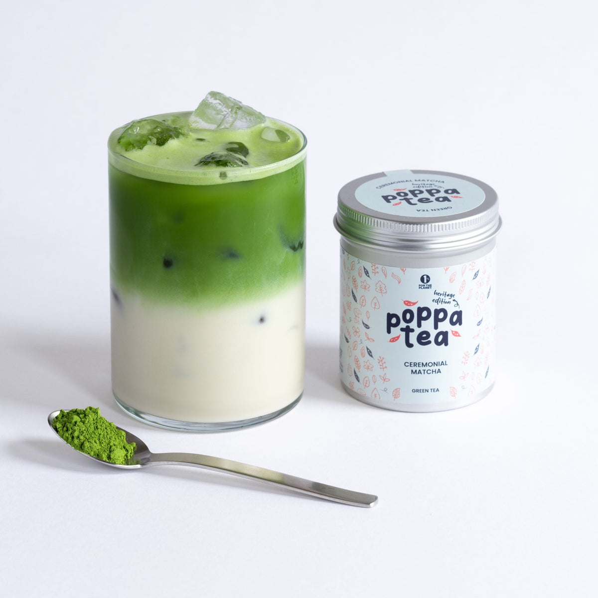Matcha iced latte drink with a canister of poppa tea on a white background