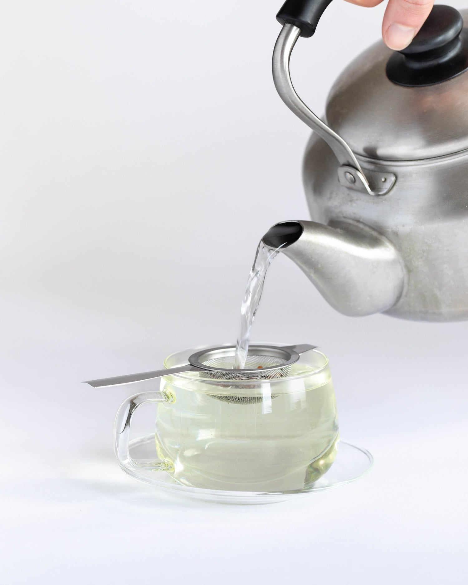 pouring hot water over genmaicha green tea to make a single serving