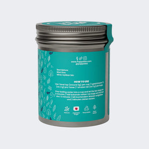 Genmaicha tea container with silver lid on a white background and a green label