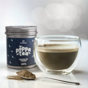 Image showing hojicha tea (roasted green tea drink) mixed with hot water and in a clear cup. Spoon with hojicha powder next to the drink.