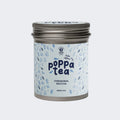 A tin of Poppa Tea ceremonial matcha green tea koku edition, featuring a light blue label with blue leaf illustrations and a metallic silver lid,