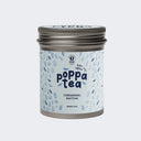 A tin of Poppa Tea ceremonial matcha green tea koku edition, featuring a light blue label with blue leaf illustrations and a metallic silver lid,