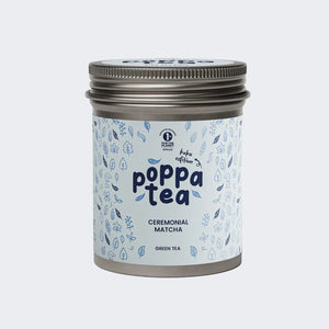 A tin of Poppa Tea ceremonial matcha green tea koku edition, featuring a light blue label with blue leaf illustrations and a metallic silver lid,