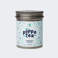 A tin container of Poppatea Ceremonial Matcha Green Tea with a blue and green floral pattern on the label.