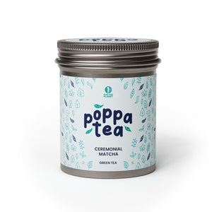 A tin container of Poppatea Ceremonial Matcha Green Tea with a blue and green floral pattern on the label.