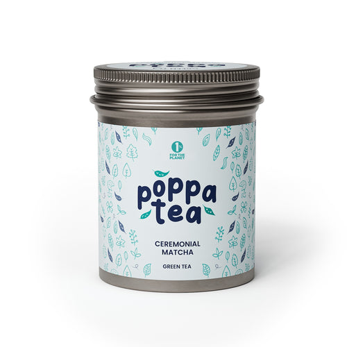 A tin container of Poppatea Ceremonial Matcha Green Tea with a blue and green floral pattern on the label.