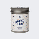 A tin container of Poppatea Ceremonial Matcha Green Tea with Chai, featuring a white label with floral and tea leaf illustrations.