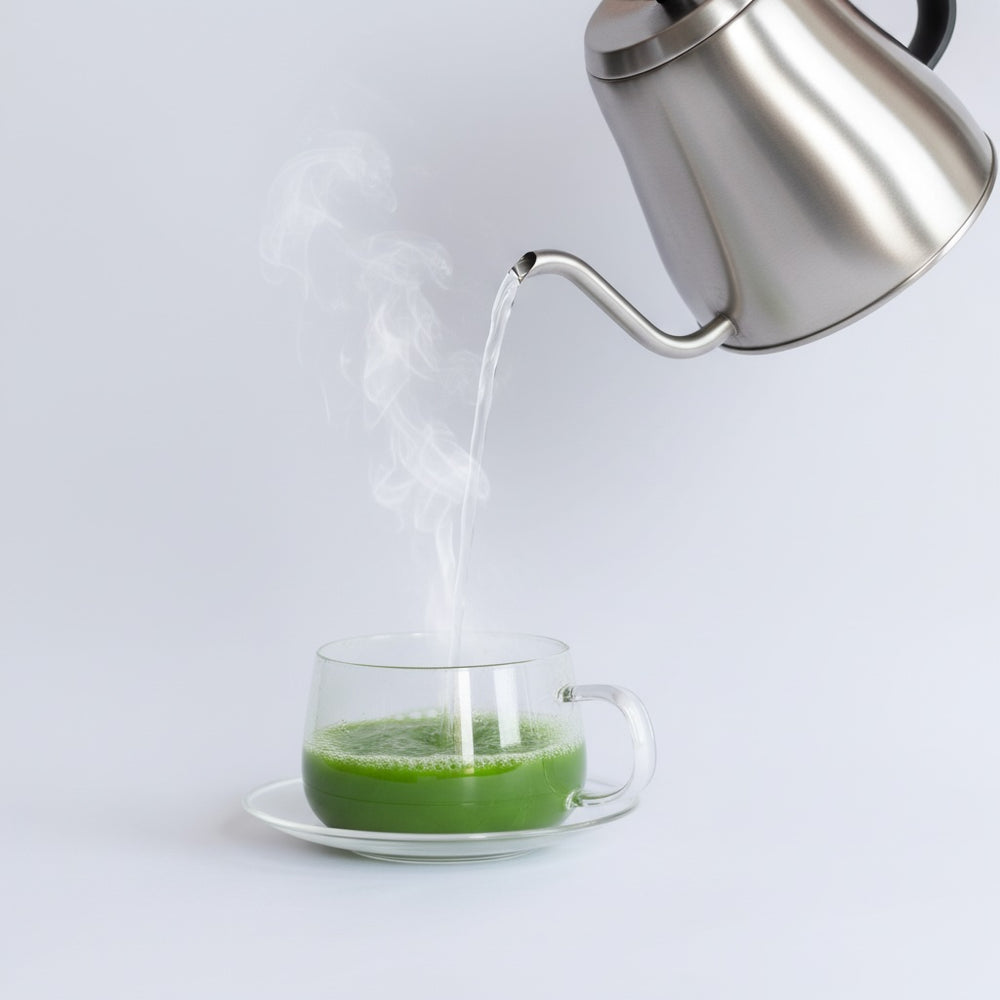 pouring hot water into cup of matcha