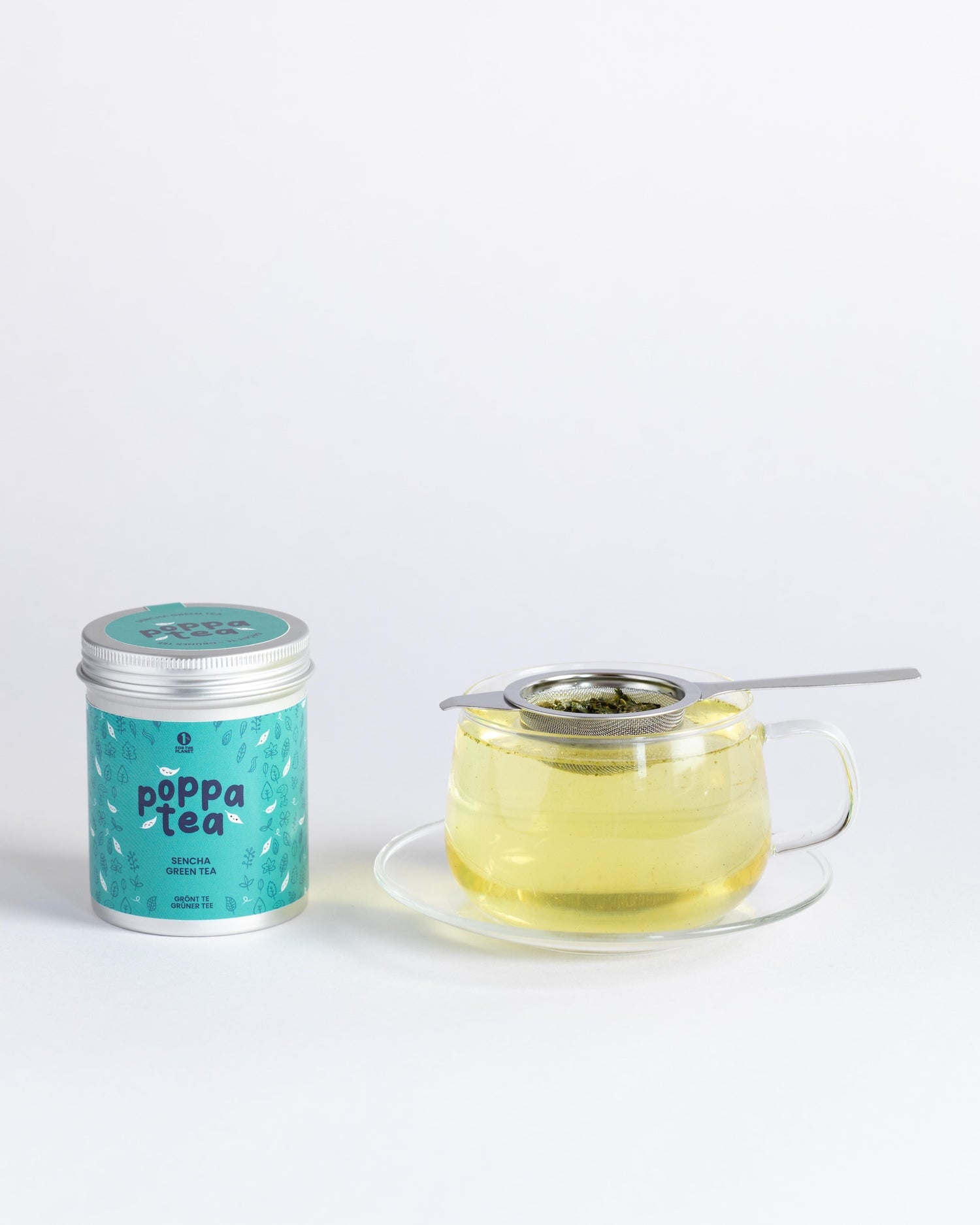 Poppa Tea packaging with a glass of sencha tea on a white background